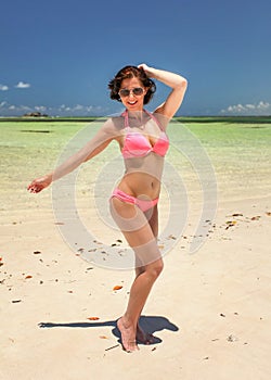 young woman with sunglasses holding her dark hair