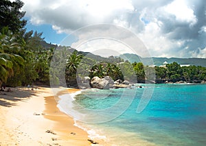 Seychelles Beach with clouds and clear water