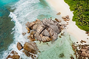 Seychelles La Digue Island. Aerial view of ocean waves and huge granite rocks on the tropical beach anse cocos with