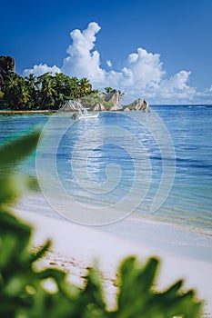 Seychelles. La Digue island famous Anse Source d'Argent beach. Pleasure tourist vacation boat in ocean shallow