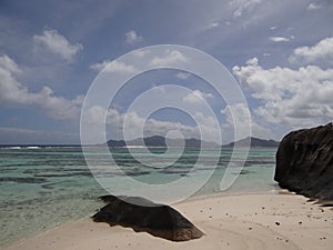 Seychelles la digue, view on praslin blue cristalline water and pink granit rock
