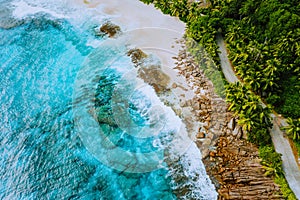 Seychelles Mahe island aerial drone landscape of coastline paradise sandy beach with palm trees and beautiful clear blue