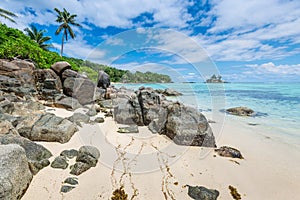 Seychelles seascape with granite boulders in the foreground