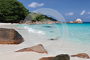 Seychelles with a turqouise water and big stones and lot of green plants