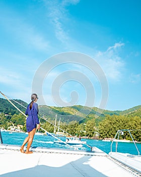 Seychelles, young men on vacation with sailing boat at the Seychelles tropical island