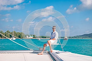 Seychelles, young men on vacation with sailing boat at the Seychelles tropical island