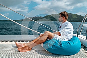 Seychelles, young men on vacation with sailing boat at the Seychelles tropical island