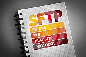 SFTP - Secure File Transfer Protocol acronym on notepad, technology concept background