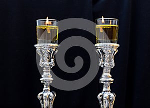 Shabbat candles. Silver candlesticks with olive oil