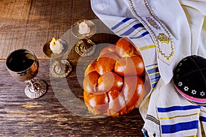 Shabbat challah bread, shabbat wine and candles on the table. Top view