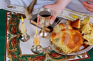 Shabbat eve table with uncovered challah bread, Sabbath candles