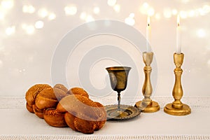 shabbat image. challah bread, shabbat wine and candles on the table