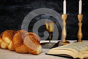 shabbat image. challah bread, shabbat wine and candles on the table