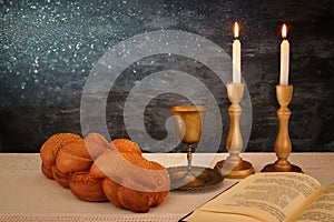 shabbat image. challah bread, shabbat wine and candles on the table