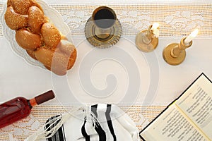 shabbat image. challah bread, shabbat wine and candles on the table. Top view.