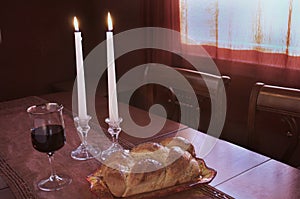 Shabbat Observance At Sunset: Challah, Glass of Wine, Two Lit Candles photo