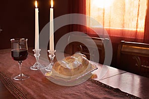 Shabbat Observance At Sunset: Challah, Glass of Wine, Two Lit Candles photo