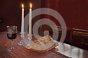 Shabbat Observance At Sunset: Challah, Glass of Wine, Two Lit Candles photo