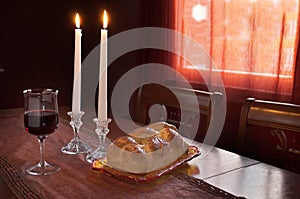 Shabbat Observance At Sunset: Challah, Glass of Wine, Two Lit Candles photo