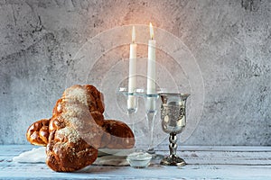 Shabbat Shalom - challah bread, shabbat wine and candles on wooden table