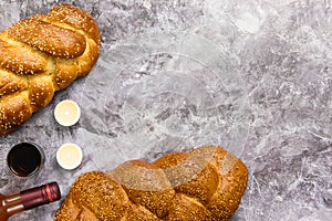 Shabbat Shalom challah bread, shabbat wine and candles on wooden table