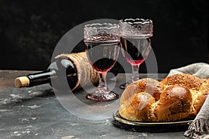 Shabbat Shalom challah bread, shabbat wine on a dark background, place for text, top view