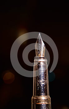 Shabby antiquarian fountain pen on blur background photo