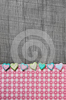 Shabby chic grey wooden background with hearts on a pink white c