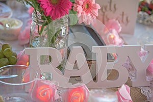 Shabby Chic pink baby shower decorations on table