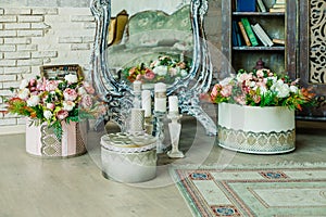 Shabby chic room interior. Wedding decor, room decorated for shabby chic rustic wedding, with many candles, flowers