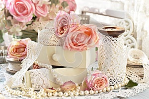 Shabby chic style decorations with roses and laces photo