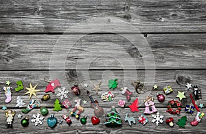 Shabby chic wooden grey christmas background with colored miniatures as decoration.