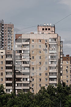 Shabby facade of an old Soviet panel apartment building in the day