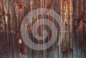 Shabby old fence of red-brown color, with gray dust, background of wooden boards, in the style of rustic, grunge,