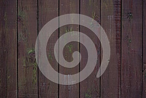 Shabby old fence of red-brown color, with moss and nails, background of wooden boards, in the style of rustic, grunge,