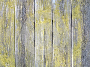 Shabby paint on old wooden planks, gray and yellow, wooden background, wooden texture