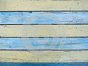 Shabby painted wooden texture, background and wallpaper - blue and yellow. Close up of wall made of wood planks