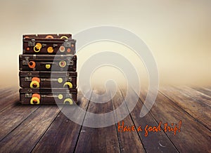 Shabby Vintage Ancient Suitcases. Background of wooden boards. Concept travel with the inscription Have a good trip