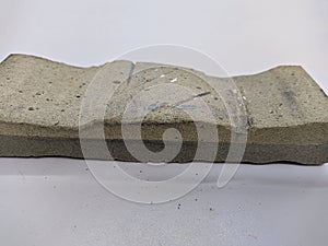 shabby whetstone on a white background closeup photo.