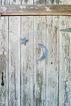 Shabby white washed door with blue moon and star - vertical form