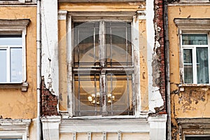Shabby window of old urban house in Moscow