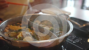 Shabu shabu and sukiyaki japanese style food in Half pot hot boiling soup ready to eat to put beef slice into. Japanese asian
