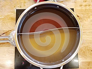 Shabu soup in the shaba pot consists of black water soup and clear soup base, divided in half. Used to boil meat and vegetables