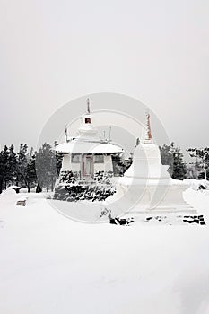 Shad Tchup Ling Buddhist monastery in winter. Stupa and pagoda on top of Kachkanar mountain, Ural, Russia