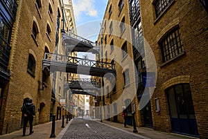 Shad Thames in London, UK. Historic Shad Thames is an old cobbled street known for it`s restored overhead bridges and walkways