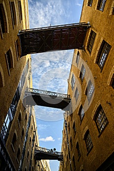 Shad Thames in London, UK. Historic Shad Thames is an old cobbled street known for it`s restored overhead bridges and walkways