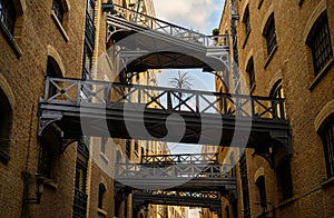 Shad Thames in London, UK. Historic Shad Thames is an old cobbled street known for it`s restored overhead bridges and walkways photo