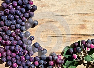 Shadberry scattered on an old table.