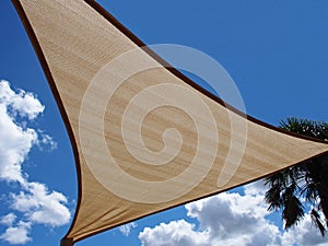 A shade sail against a blue sky