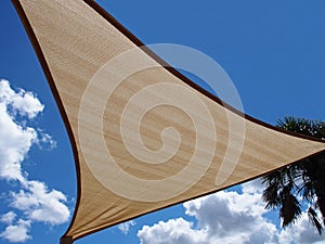 A shade sail against a blue sky photo